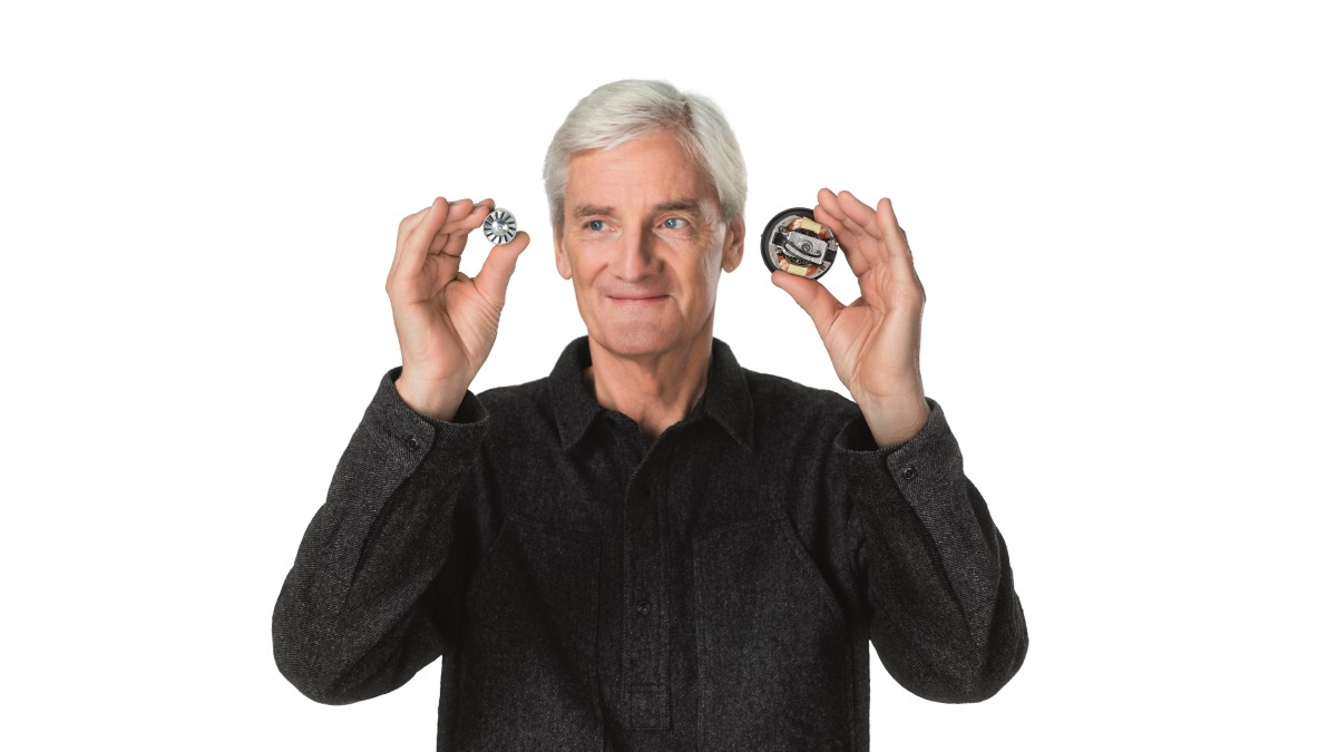James Dyson with a motor from the Supersonic Hair Dryer and a conventional hair dryer motor