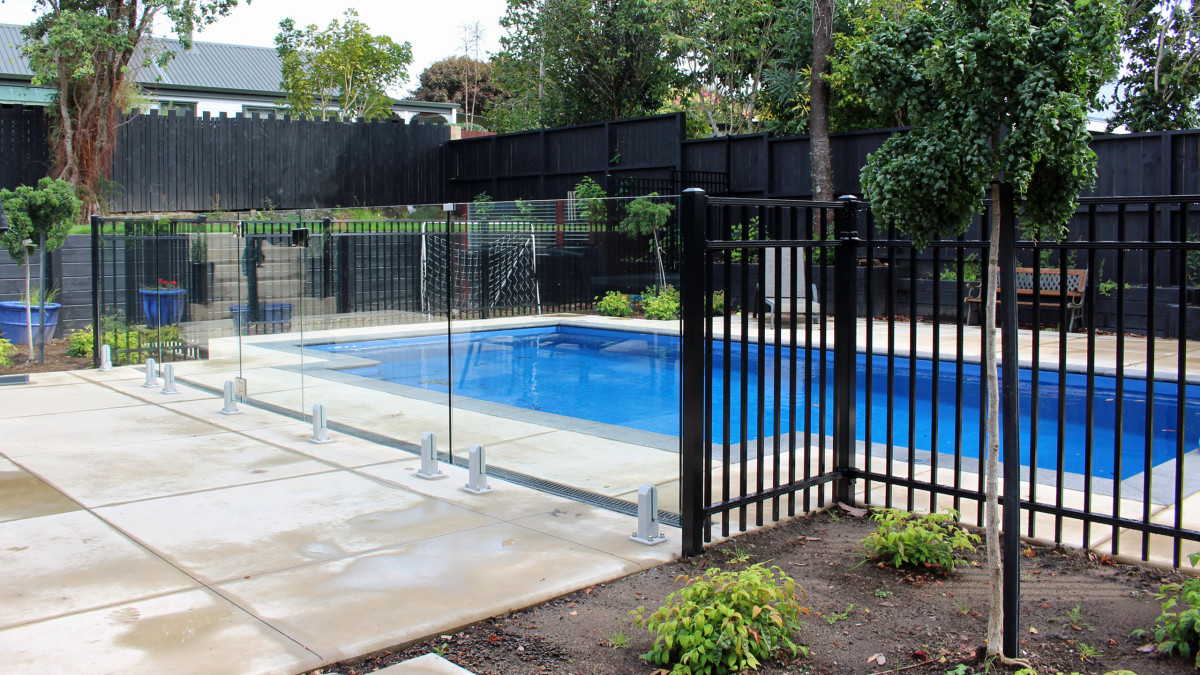 Frameless Glass Mini Post Balustrades and matching glass gates combined with Contemporary Pool fencing.