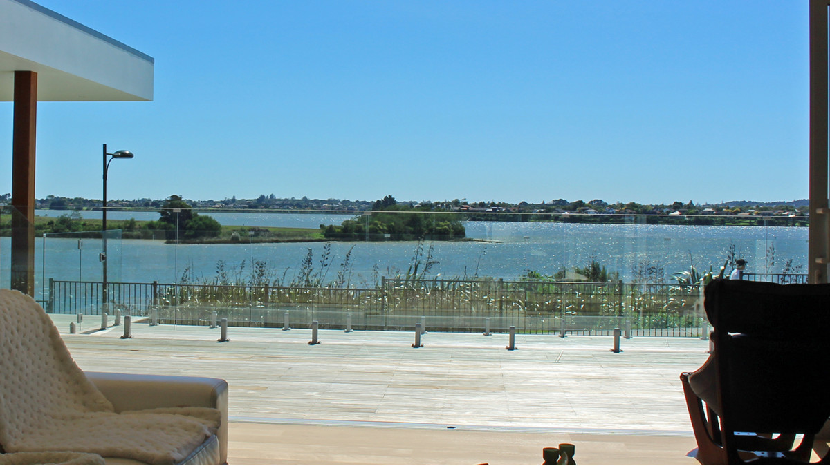 Frameless Glass balustrades Edgetec Mini Post installed as pool fencing viewed from inside this modern home.