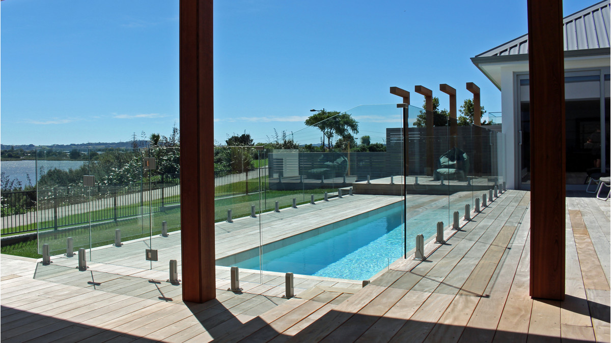 Frameless Glass balustrades Edgetec Mini Post installed for pool fencing on this stunning modern home.