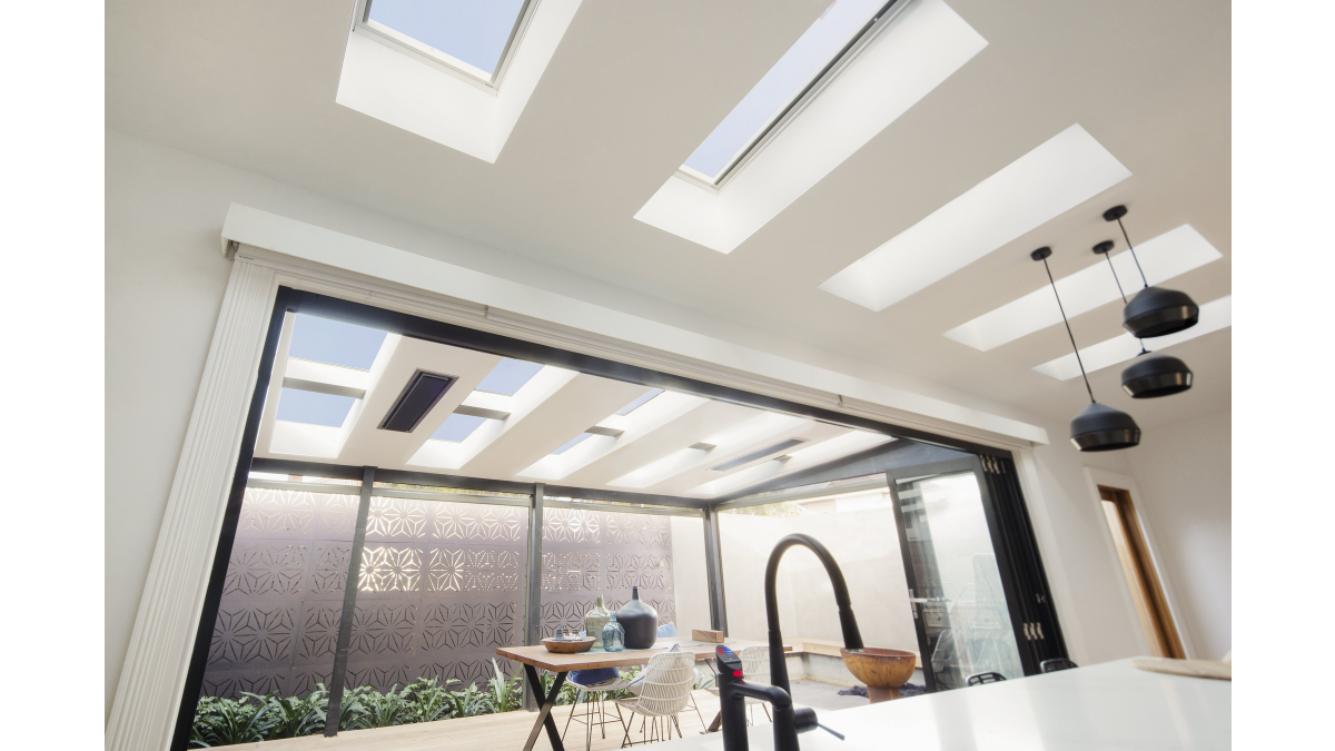 Low pitched skylights brighten a kitchen and outdoor patio.