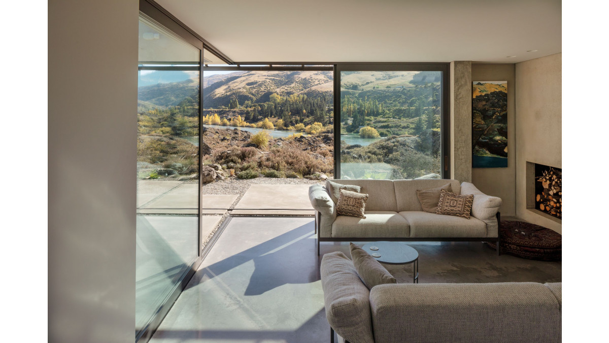 Bi-parting Altherm APL Architectural Series sliding doors in the living room recede to connect with the landscape.