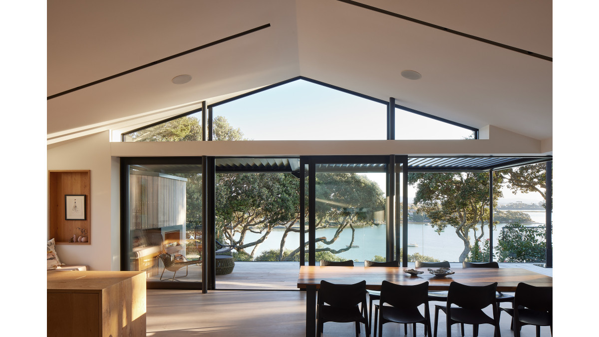 The joinery in Duratec Matt Black — including these APL Architectural Series stacker sliding doors and Metro Series clerestory windows — blends beautifully with the landscape.
