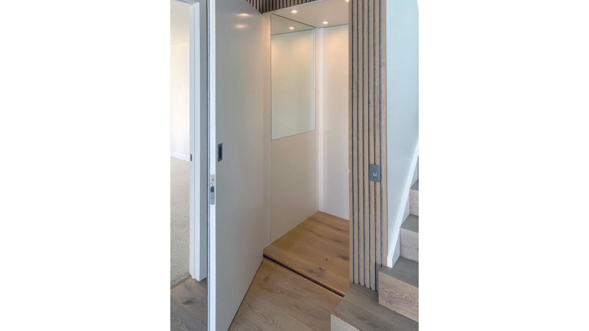 A half height mirror creates a feeling of space and the timber flooring matches the hallway for a seamless integration.